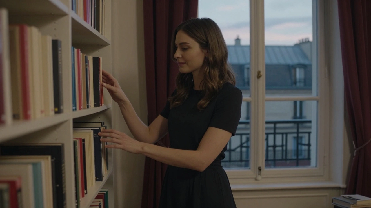 A woman standing by a bookshelf filled with philosophy and travel books in a cozy Parisian flat.